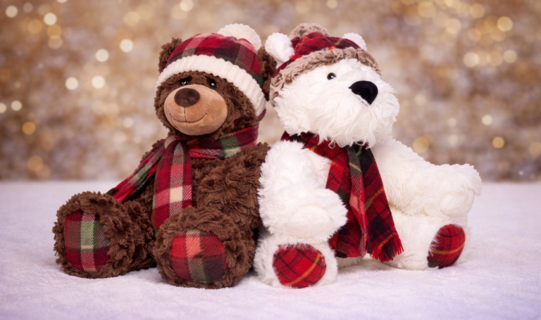 plush bears sitting on christmas scenery